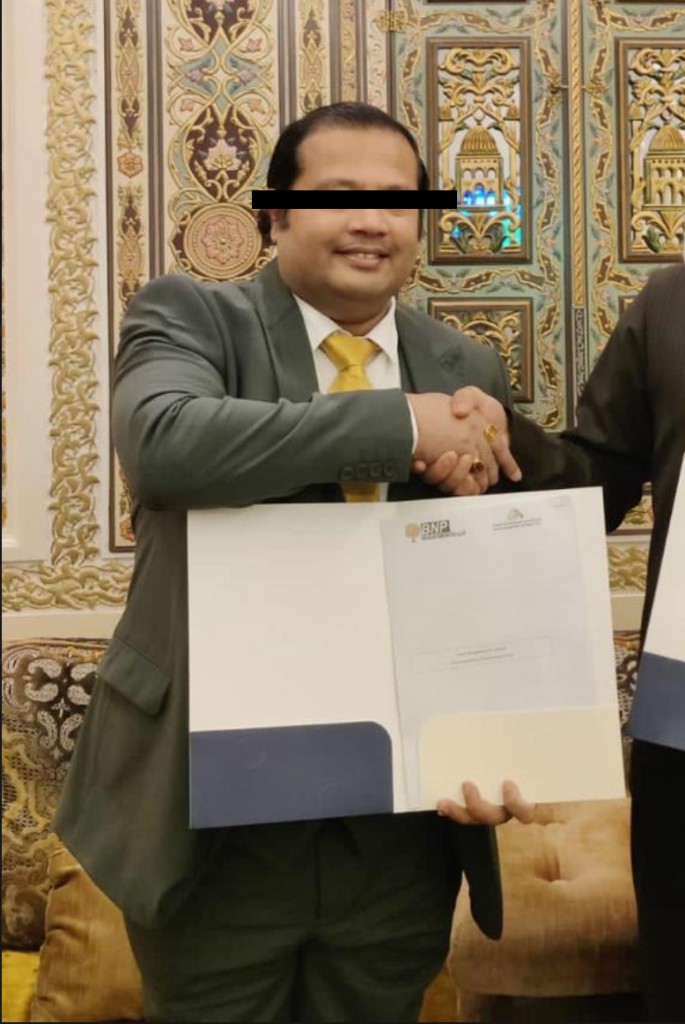 Man in suit holding document